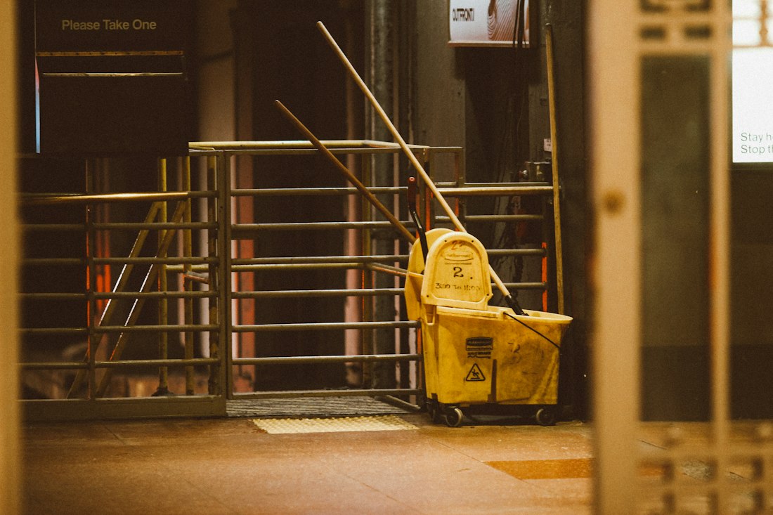 Mop bucket and wet floor sign during a service